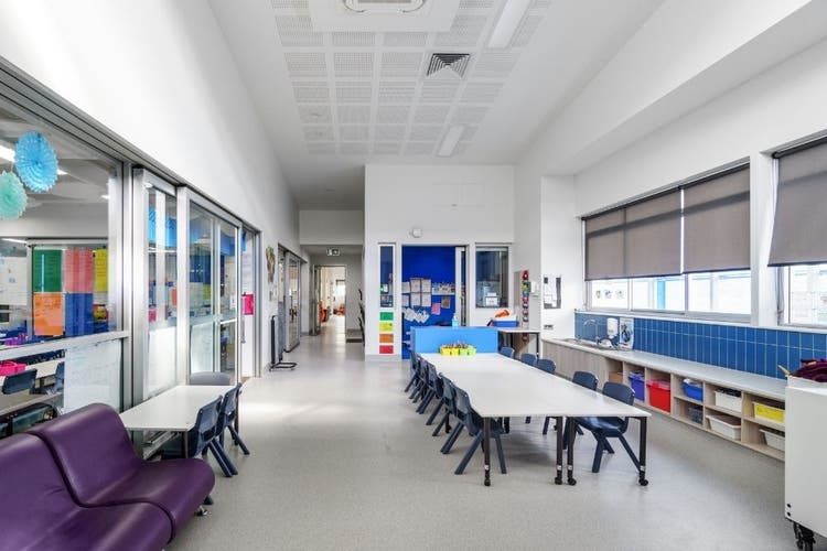 Learning area in K-block showing tables and chairs in a brightly lit area.