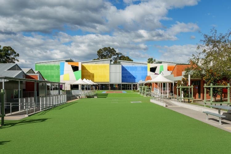 The common area is in the foreground and brighly coloured K-block is in the background.